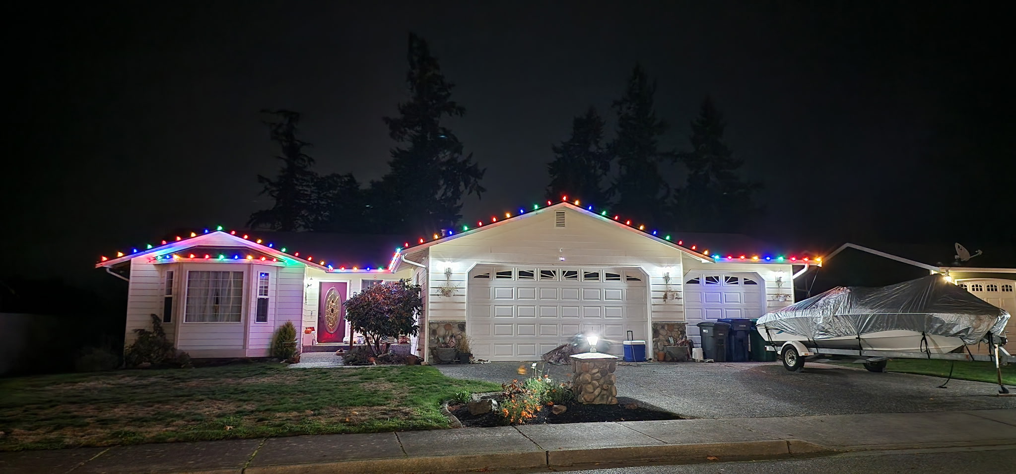 A Lake Stevens home outlined in multi-color holiday lights at night